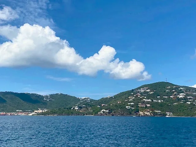 Green Caribbean hillsides above deep blue water at St Thomas
