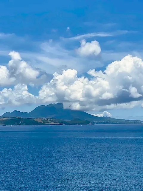 Deep blue bay below layered coastal mountains